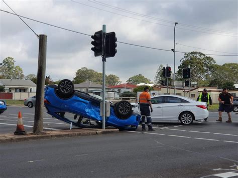 Police were directing traffic through a busy city intersection after it was blocked by a car which flipped onto its roof in a two-vehicle crash. . Toowoomba car accident 2023